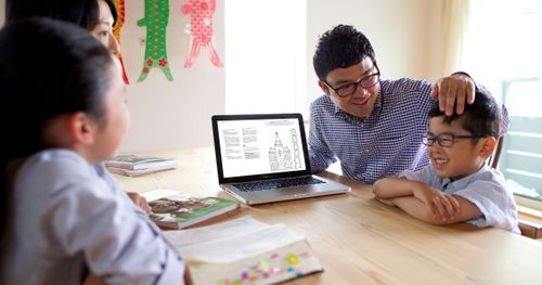 family studying using laptop