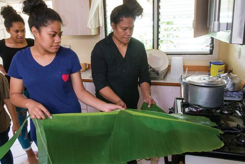 mother teaching daughter kitchen skills