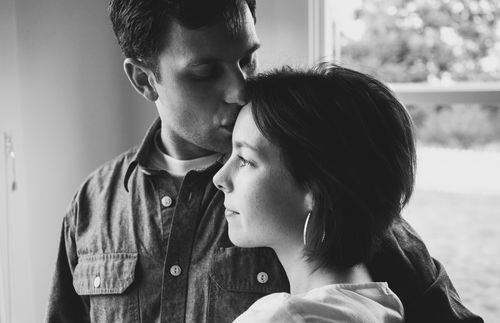 husband kissing forehead of wife