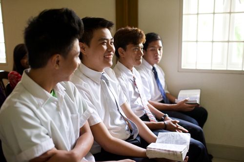 group of young men sitting in a Church class