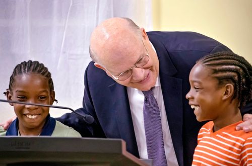 Elder Reunlund talking to two boys at church