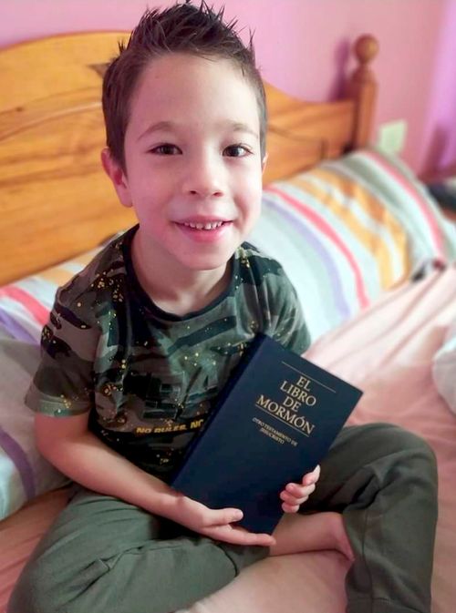 boy holding Book of Mormon