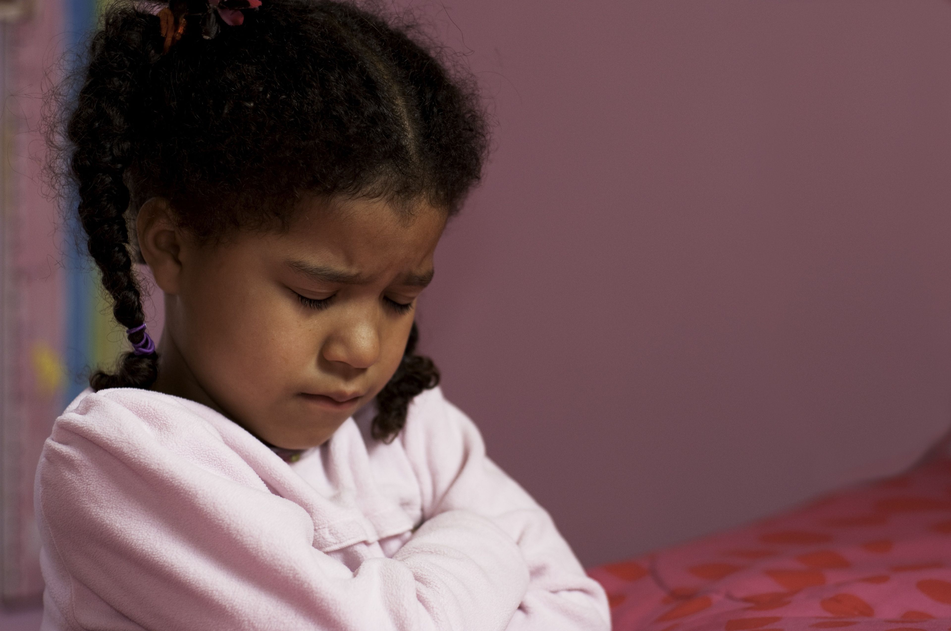A young girl prays before she goes to bed.