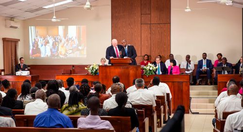 Elder Renlund speaking at Church building