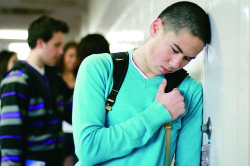 young man leaning against locker