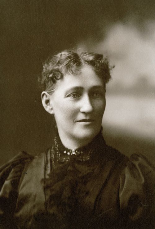 A portrait of George Albert Smith’s mother, with short, curly dark hair and a blouse with lace.