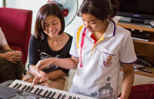 mother and daughter playing keyboard