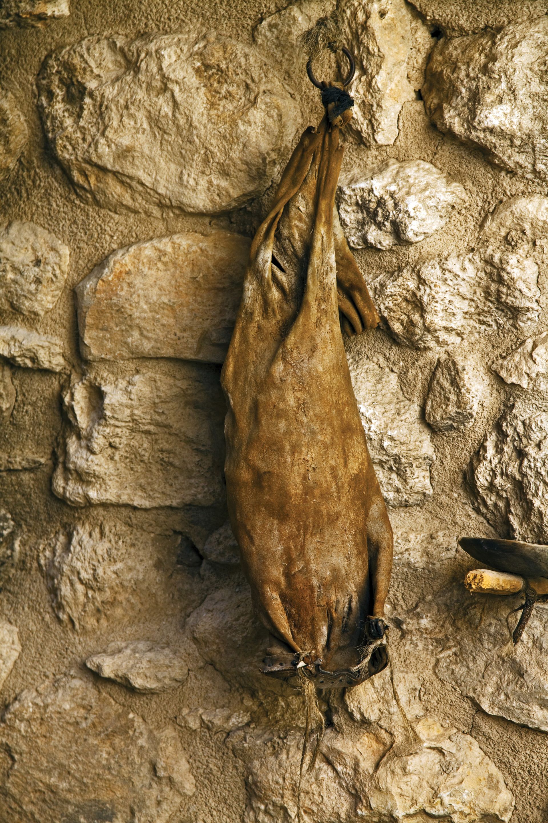 A wineskin lying on a stone path.