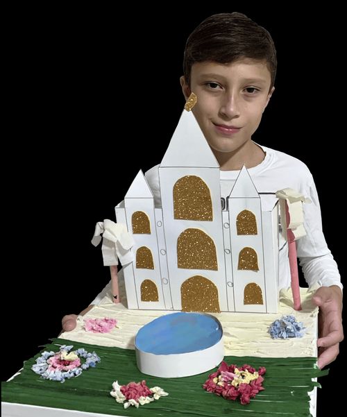 Boy holding a paper model of a temple