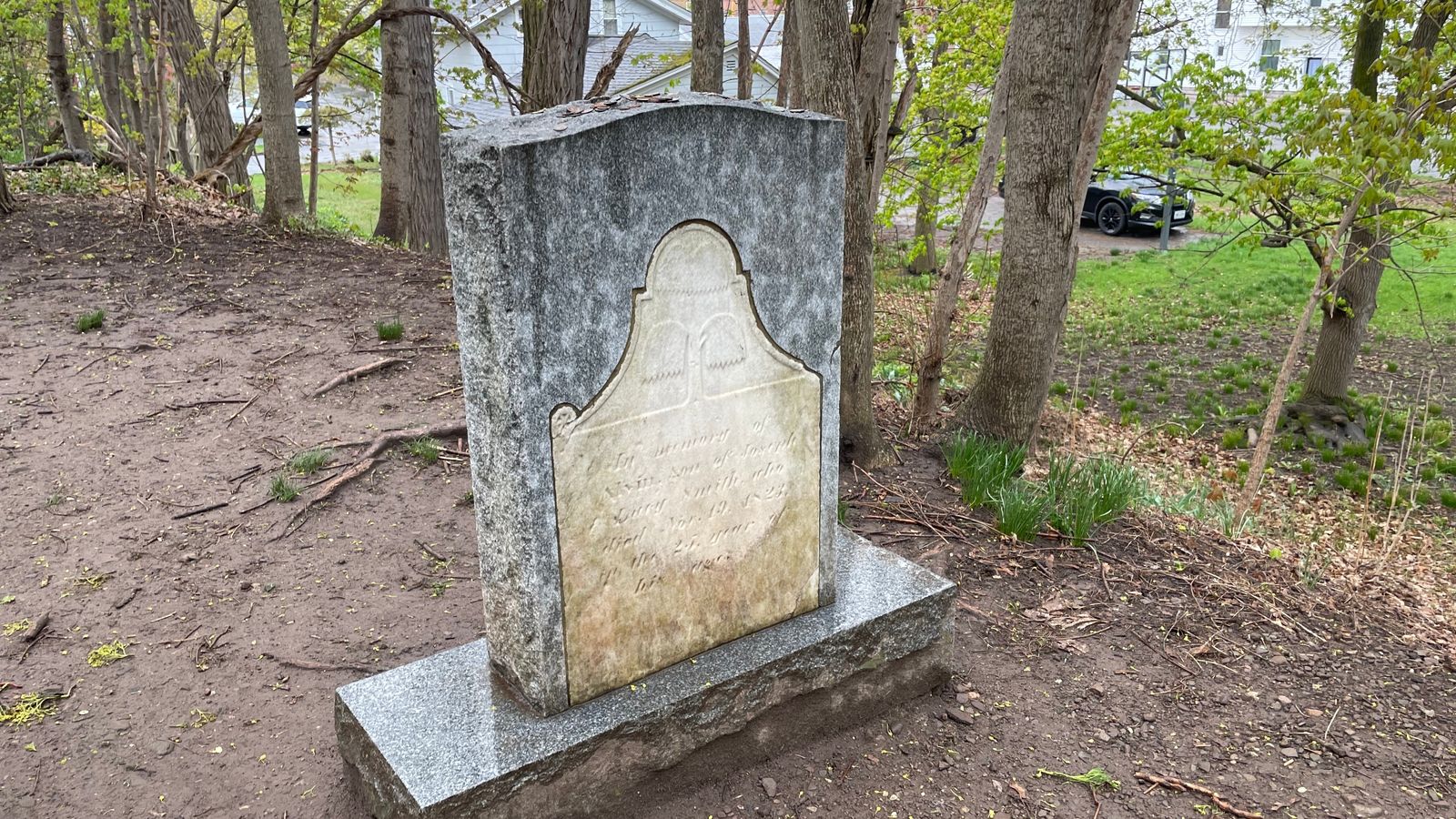 An old headstone encased in new granite that reads ‘In Memory of Alvin, Son of Joseph and Lucy Smith, who died Nov. 19, 1823, in the 25th year of his life.’ 