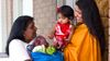 woman delivering groceries to a mother and baby