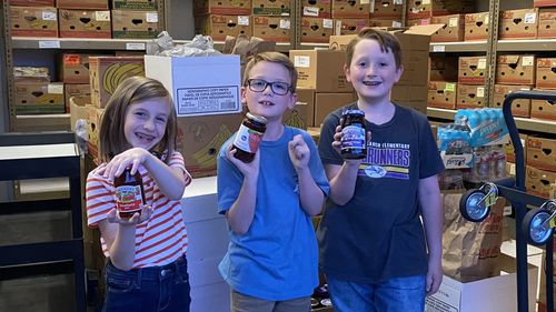 Children collecting jam for those in need.