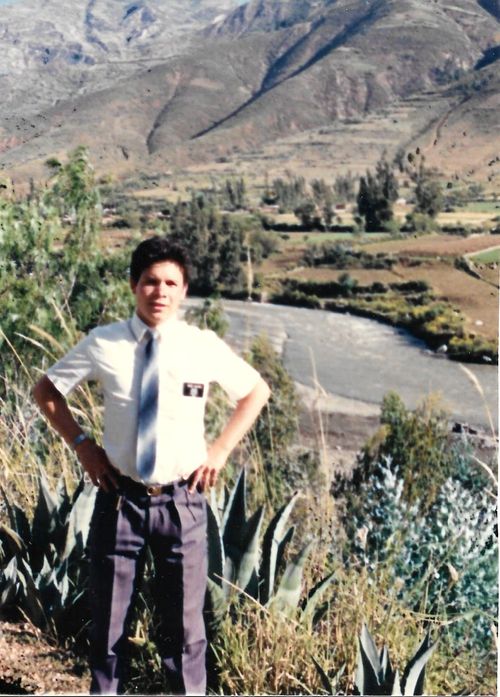 Manuel Navarro poses in a field while wearing his missionary tag.