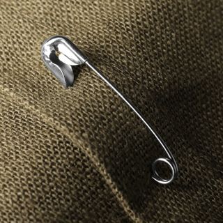 Safety pin attached to clothing