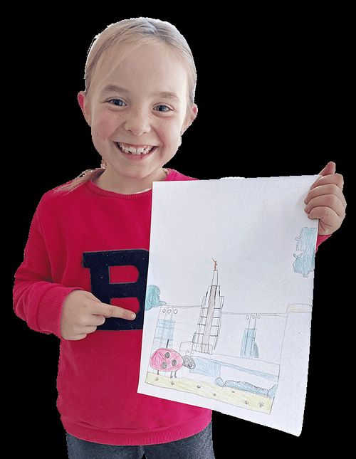 Girl holding her drawing of a temple