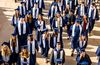 students walking in graduation uniforms